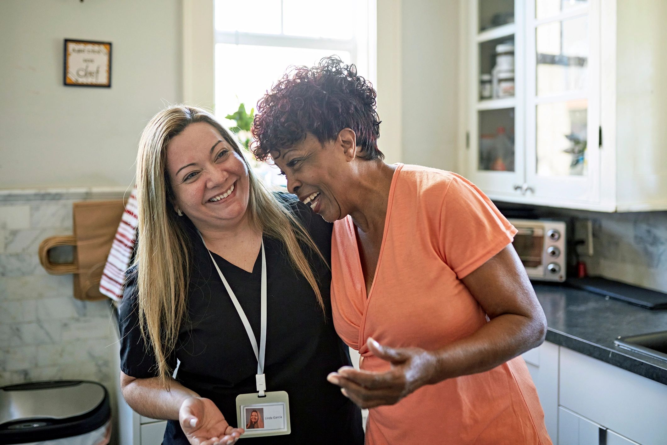Caregiver and senior woman sharing a warm moment