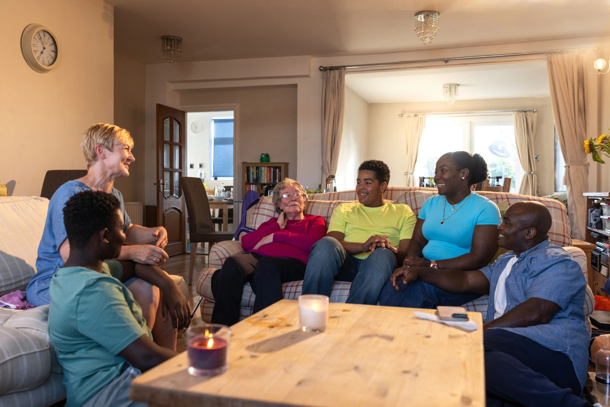 Multigenerational family sitting together in a living room