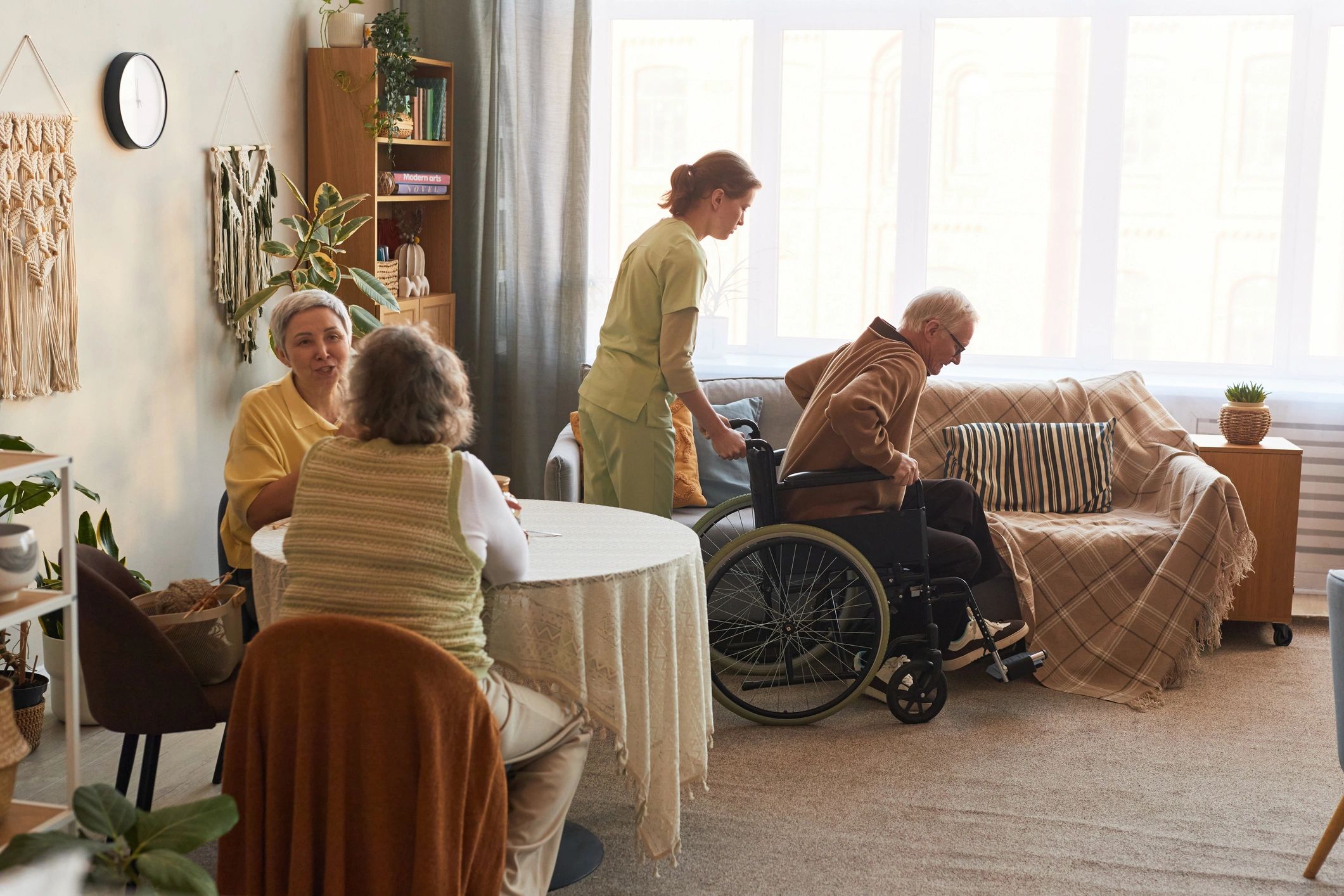 Caregiver assisting a senior man with mobility support