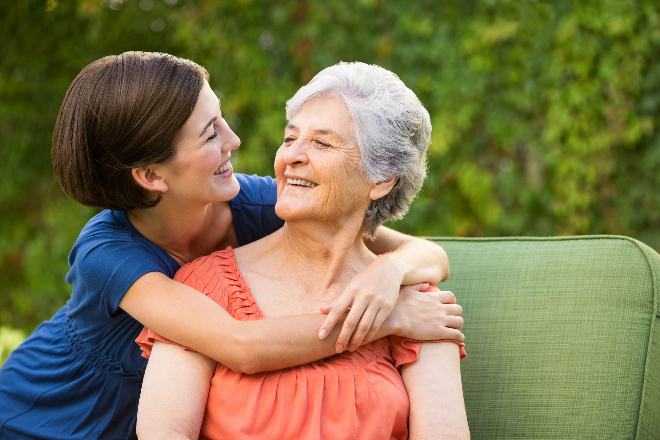 Senior woman hugged by granddaughter